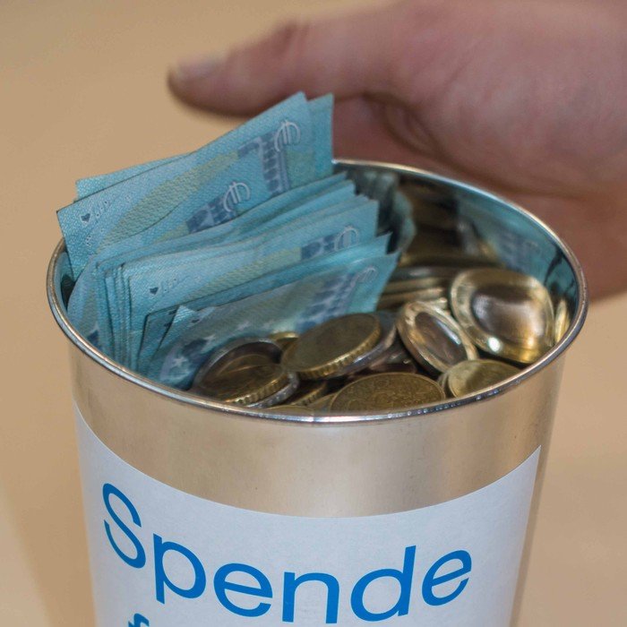 eine Spendenbüchse, gefüllt mit Geld